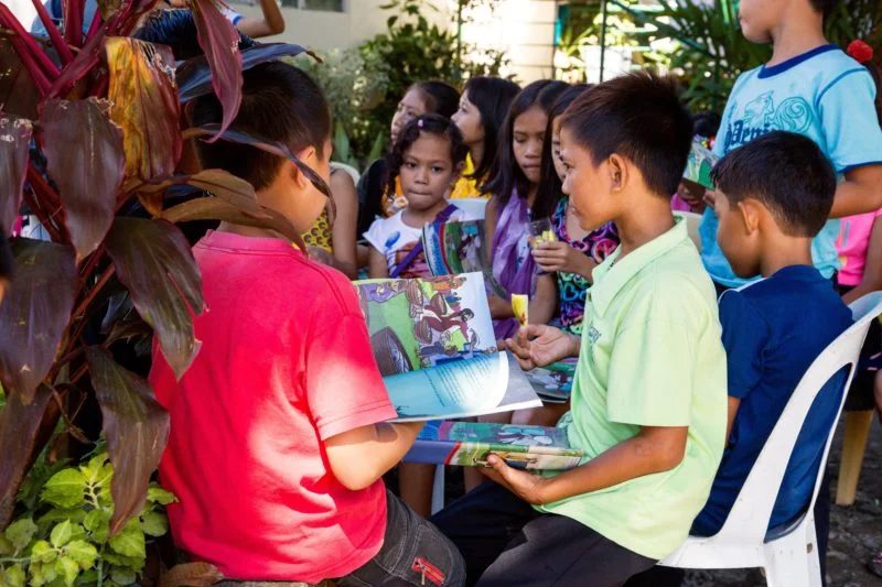 A group of children are participating in a Bible study, which is part of our Peace and Faith program.